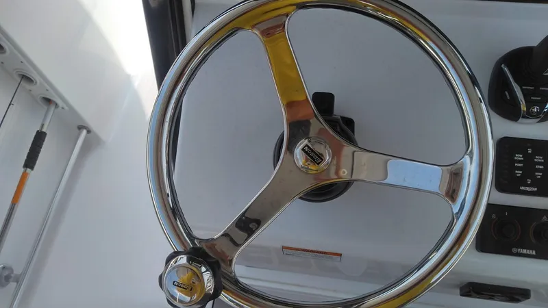 Slide: The Image of Steering wheel of a 2022 Sportsman Open 302 Center Console boat. - 17