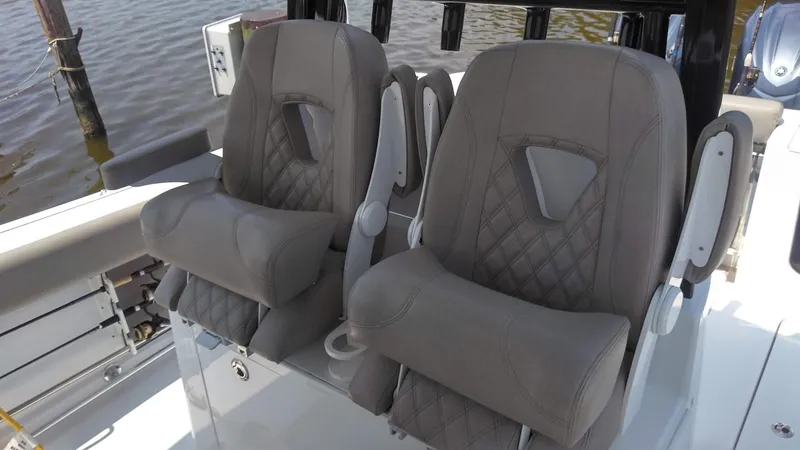 Slide: The Image of 2022 Sportsman Open 302 Center Console boat seats with diamond stitching. - 18