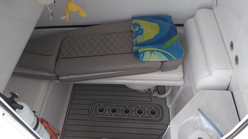 Slide: The Image of 2022 Sportsman Open 302 Center Console cabin interior with seating and storage. - 19