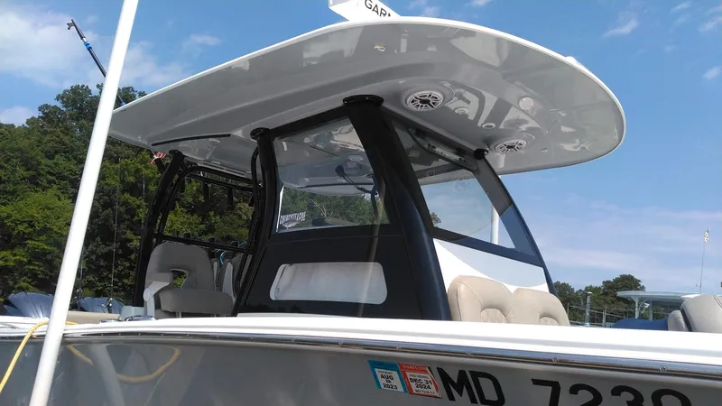 Slide: The Image of 2022 Sportsman Open 302 Center Console boat docked, partial side view. - 2