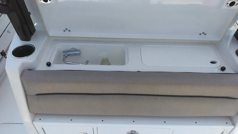 Slide: The Image of 2022 Sportsman Open 302 Center Console boat sink and storage area. - 5