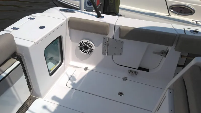 Slide: The Image of 2022 Sportsman Open 302 Center Console boat interior with seating and storage. - 7