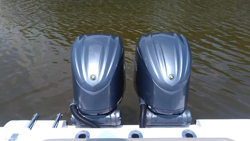 Slide: The Image of Twin outboard motors on a 2022 Sportsman Open 302 Center Console boat. - 9