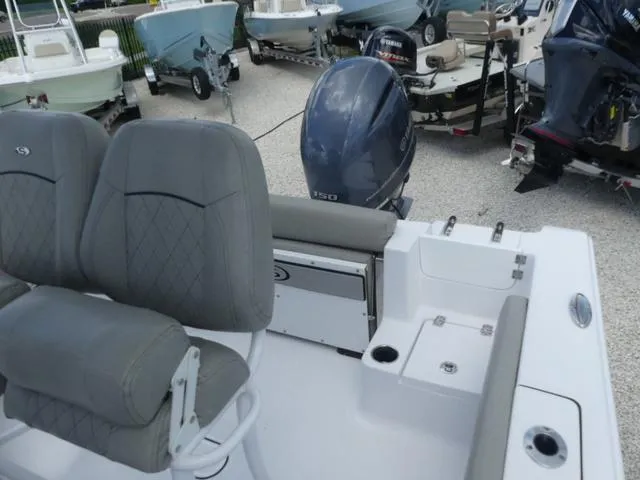 Slide: The Image of 2021 Sportsman Open 212 CC boat with dual seats and outboard motor. - 13