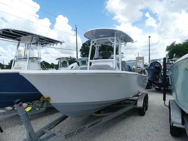 Slide: The Image of 2021 Sportsman Open 212 Cc boat on trailer under blue sky. - 3