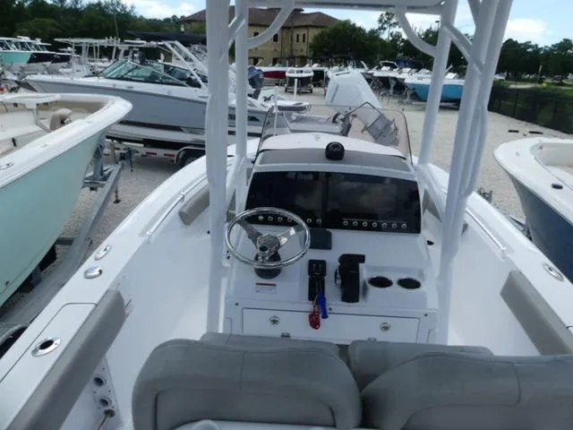 Slide: The Image of 2021 Sportsman Open 212 CC boat dashboard and controls in a marina. - 8
