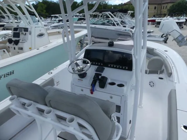 Slide: The Image of 2021 Sportsman Open 212 CC center console boat interior with helm and seating. - 9