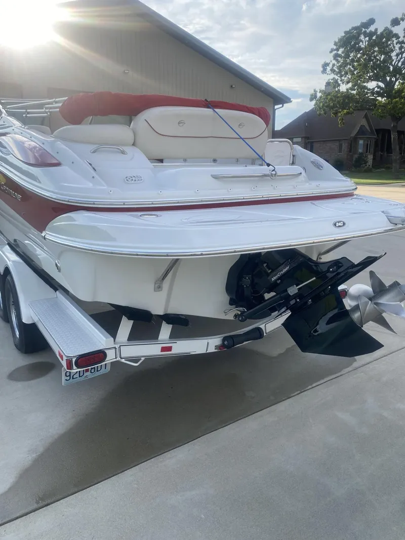 Slide: The Image of 2011 Crownline 240EX boat on trailer, rear view, sunny day. - 3