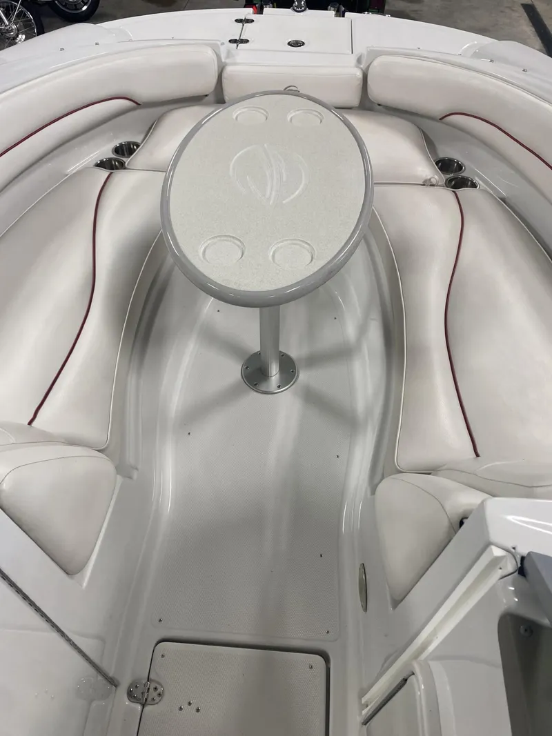 Slide: The Image of 2011 Crownline 240EX boat interior with white seating and central table. - 7
