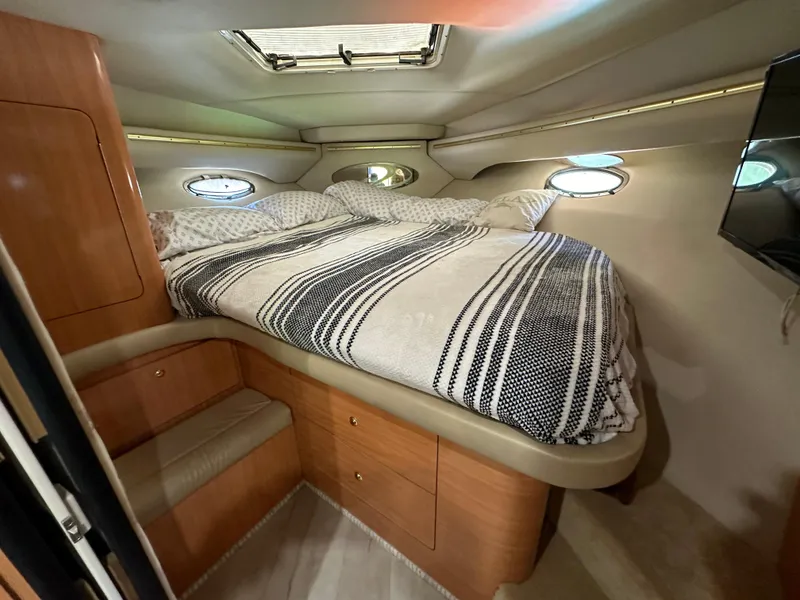 Slide: The Image of Interior cabin of 1999 Regal Commodore 402 with bed and portholes. - 3