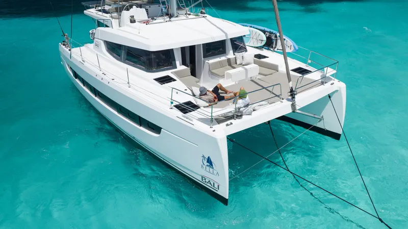 The Image of 2021 Bali 4.8 catamaran anchored in clear turquoise water, featuring spacious deck and modern design. - 1