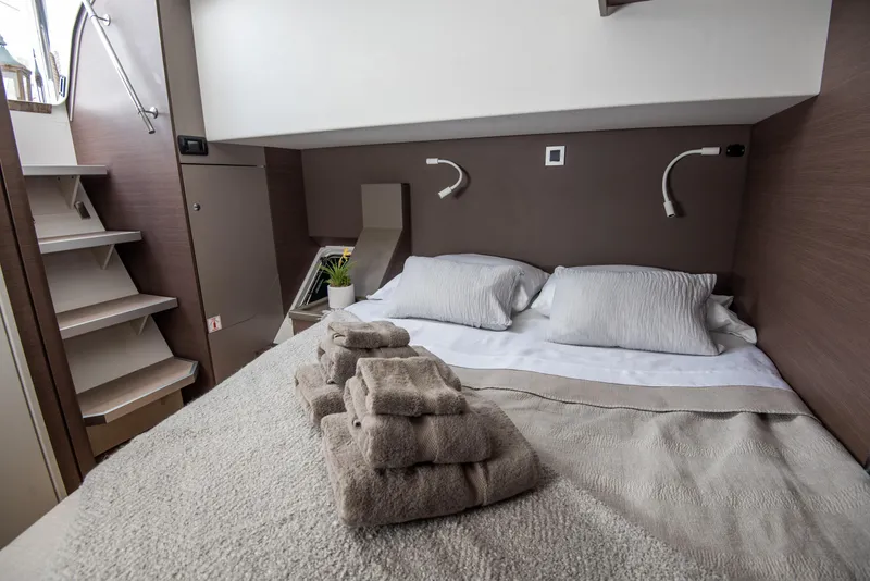 Slide: The Image of Cozy bedroom in 2021 Bali 4.8 yacht with neatly arranged towels and modern decor. - 31