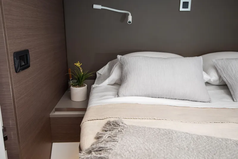 Slide: The Image of Cozy bedroom interior in Bali 4.8 yacht, featuring neutral tones and modern design. - 33