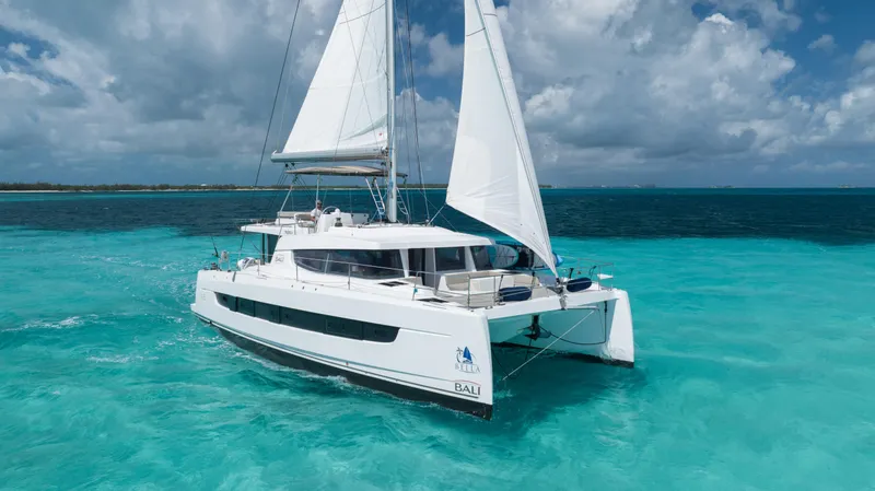 Slide: The Image of Sailing catamaran Bali 4.8, 2021 model, cruising in turquoise ocean waters under a cloudy sky. - 4