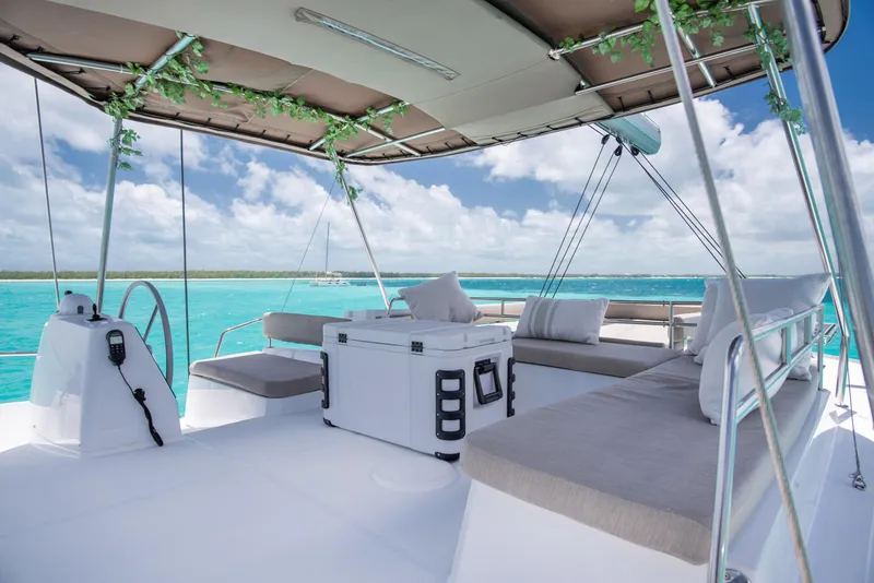 Slide: The Image of Luxurious 2021 Bali 4.8 catamaran deck with seating, sailing on turquoise waters. - 7