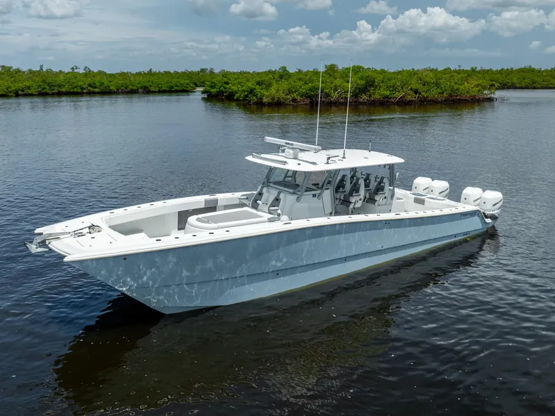 Slide: The Image of 2019 Freeman 42 LR boat on calm water with lush green background. - 1