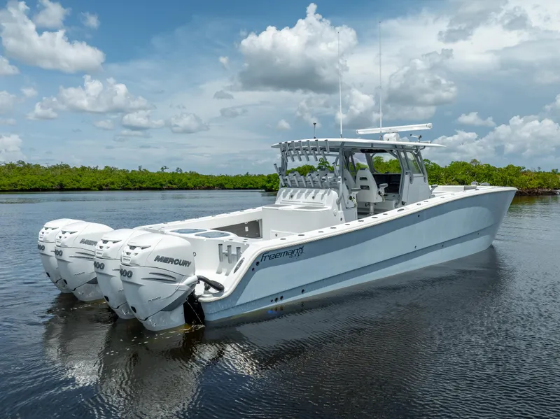 Slide: The Image of 2019 Freeman 42 LR boat with triple Mercury engines on calm water. - 11