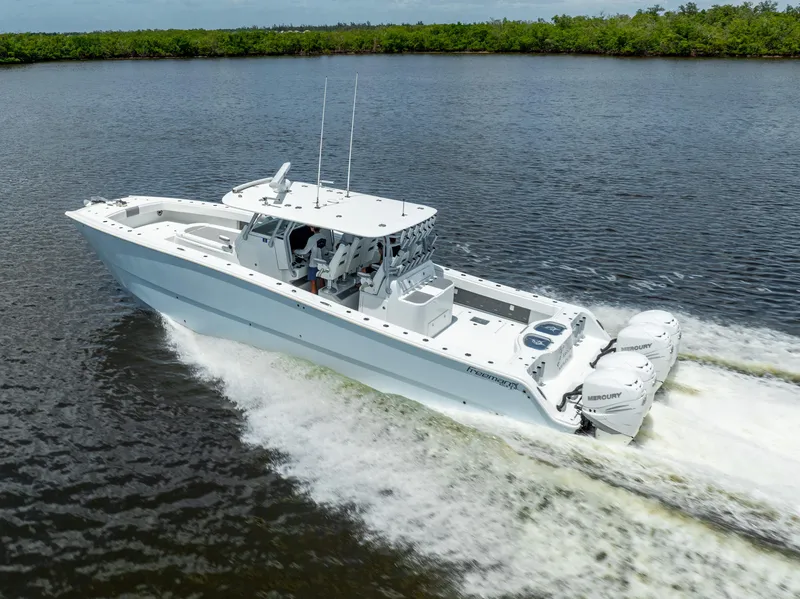 Slide: The Image of 2019 Freeman 42 LR boat cruising on a river with twin outboard engines. - 17