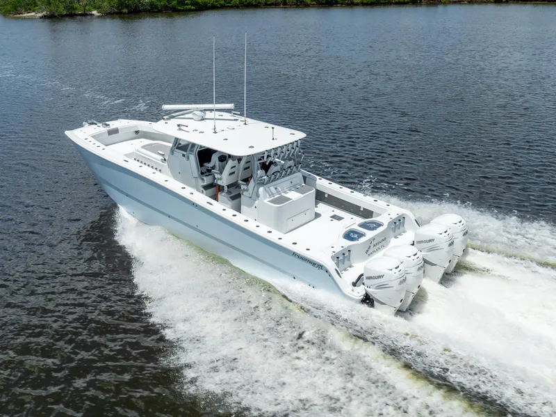 Slide: The Image of 2019 Freeman 42 LR boat cruising on water with twin outboard engines. - 18