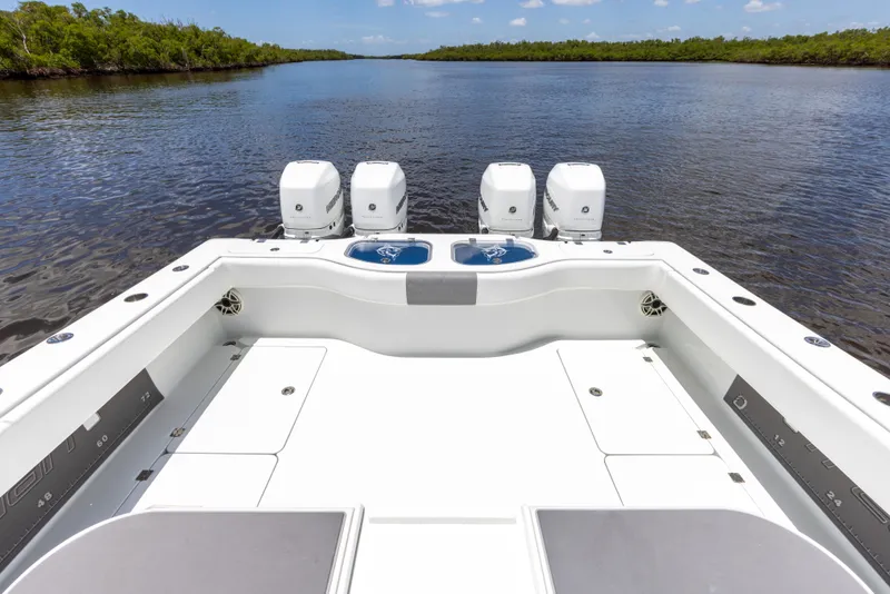 Slide: The Image of 2019 Freeman 42 LR boat with quad outboard engines on calm water. - 25