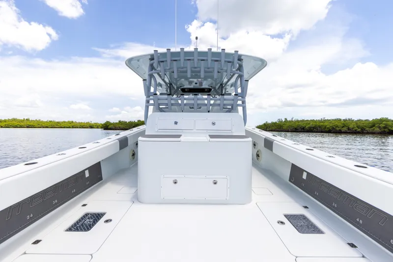 Slide: The Image of 2019 Freeman 42 LR boat interior with open deck and blue sky background. - 28
