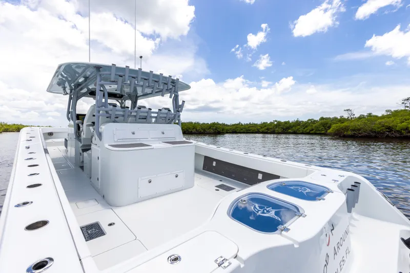 Slide: The Image of 2019 Freeman 42 LR boat on a calm river under a blue sky. - 29