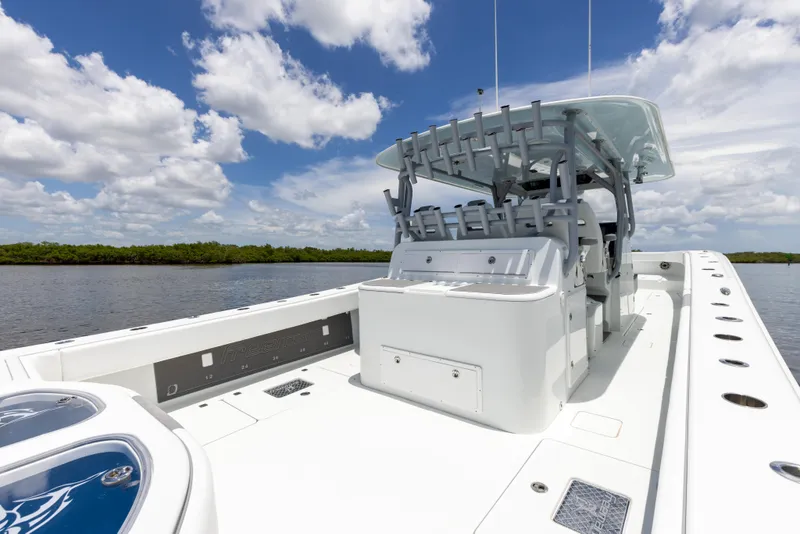 Slide: The Image of 2019 Freeman 42 LR boat with spacious deck and seating, under a clear blue sky. - 30