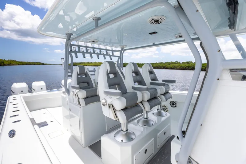 Slide: The Image of 2019 Freeman 42 LR boat with four cushioned seats on a sunny day. - 33