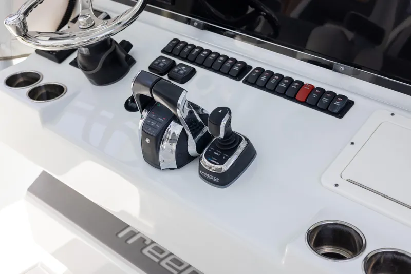 Slide: The Image of Control panel of a 2019 Freeman 42 LR boat with steering wheel and throttle. - 43