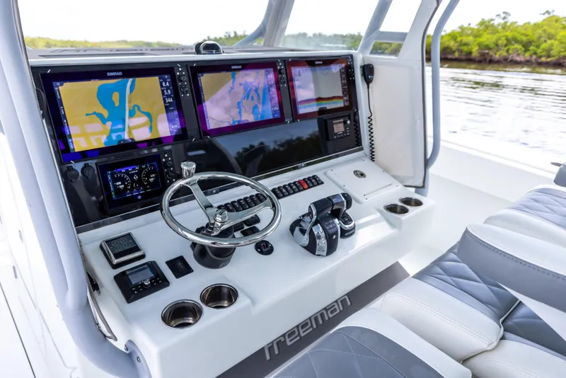 Slide: The Image of Freeman 42 LR 2019 boat dashboard with navigation screens and controls. - 48