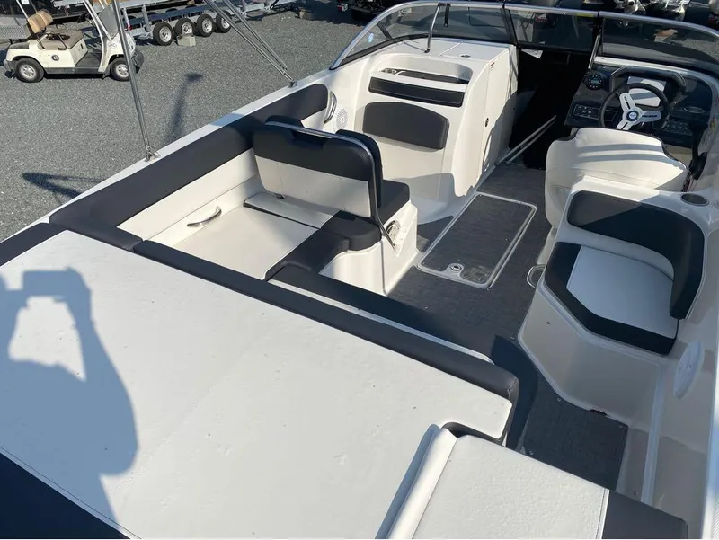 Slide: The Image of 2021 Bayliner VR6 Bowrider Outboard interior with seating and steering console. - 10