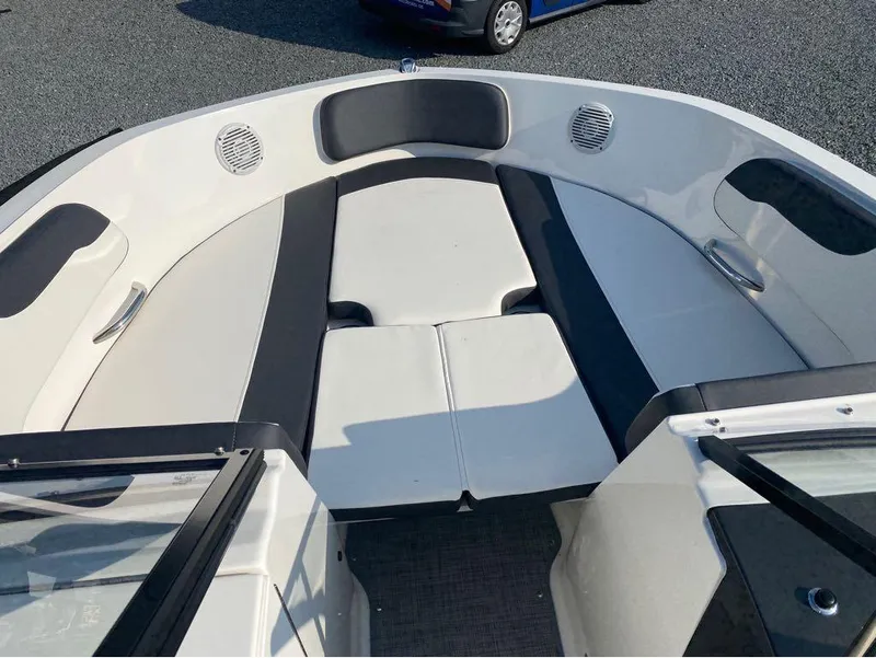 Slide: The Image of 2021 Bayliner VR6 Bowrider Outboard, spacious bow seating area with black and white upholstery. - 3