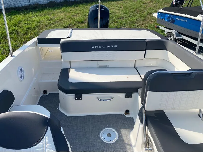 Slide: The Image of 2021 Bayliner VR6 Bowrider Outboard interior with seating and outboard motor. - 7