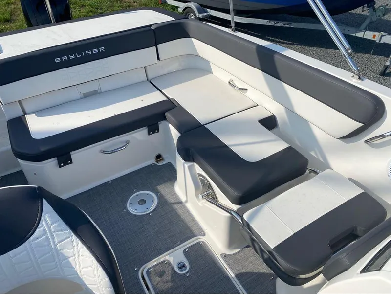 Slide: The Image of 2021 Bayliner VR6 Bowrider Outboard interior seating area with black and white upholstery. - 9