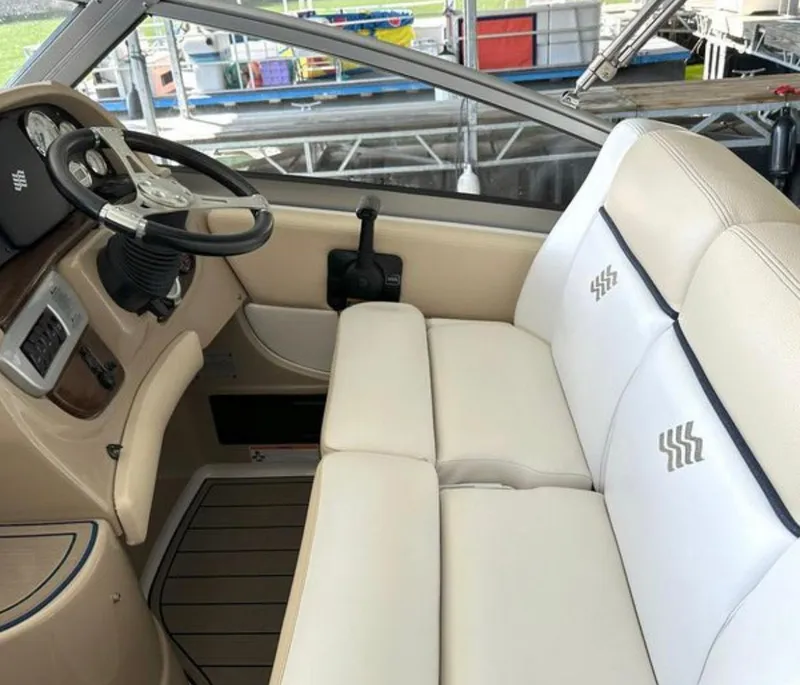 Slide: The Image of Interior cockpit of 2008 Four Winns V258 boat with beige seating and steering wheel. - 6