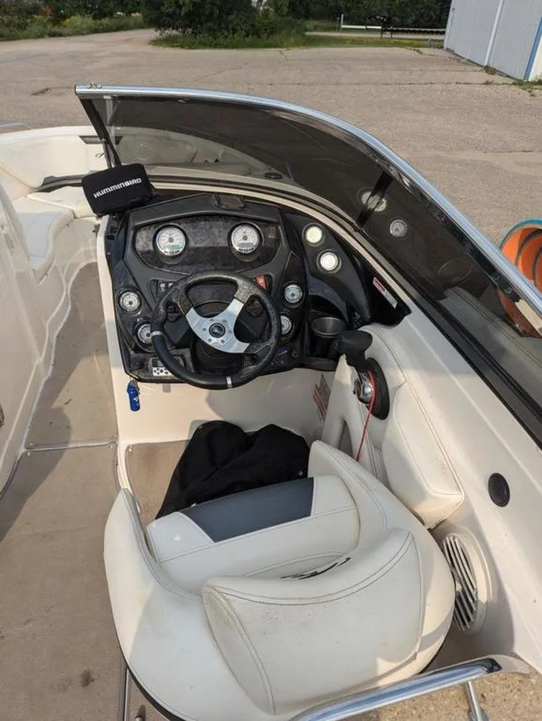 Slide: The Image of 2011 Monterey 264 FS boat cockpit with steering wheel and dashboard. - 10