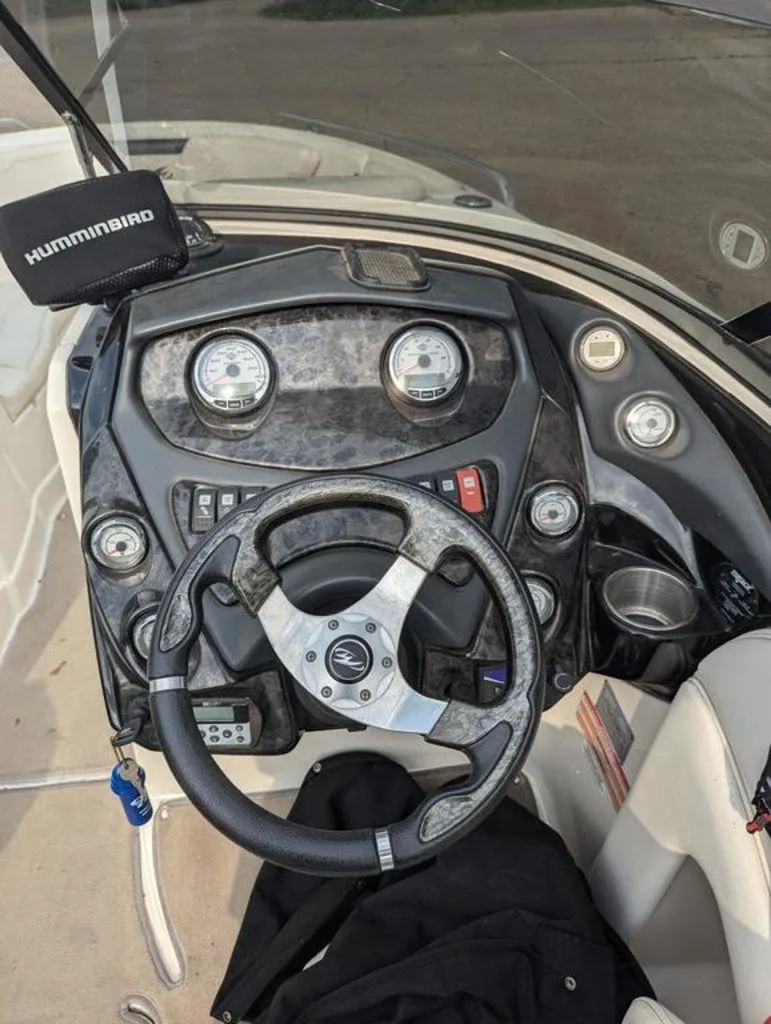 Slide: The Image of 2011 Monterey 264 FS boat dashboard with steering wheel and Humminbird device. - 11
