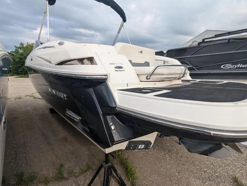 Slide: The Image of 2011 Monterey 264 FS boat on a trailer, rear view, black and white exterior. - 5