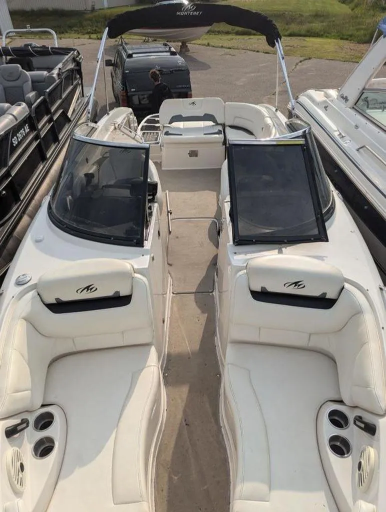 Slide: The Image of 2011 Monterey 264 FS boat with white interior and black canopy. - 9