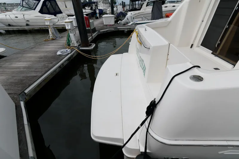 Slide: The Image of 2000 Silverton 330 Sport Bridge docked at marina. - 11