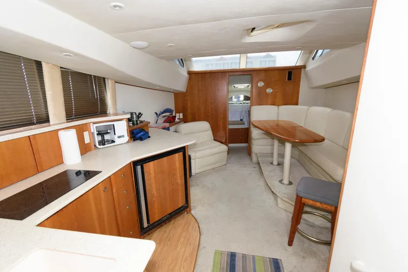 Slide: The Image of Interior of 2000 Silverton 330 Sport Bridge yacht with kitchen and dining area. - 12