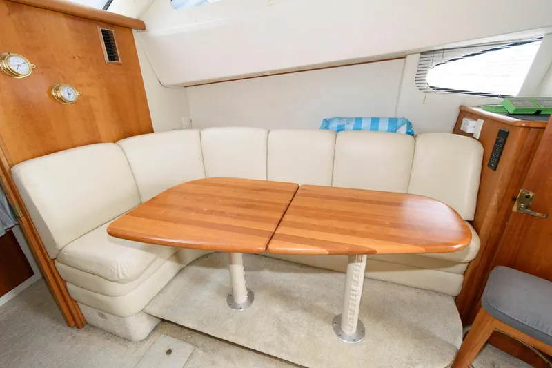 Slide: The Image of Interior seating and table of 2000 Silverton 330 Sport Bridge yacht. - 13