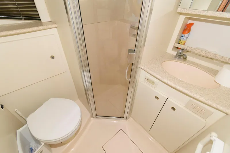 Slide: The Image of 2000 Silverton 330 Sport Bridge bathroom with shower, toilet, and sink. - 17