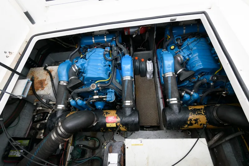 Slide: The Image of Engine compartment of a 2000 Silverton 330 Sport Bridge with twin blue engines. - 18