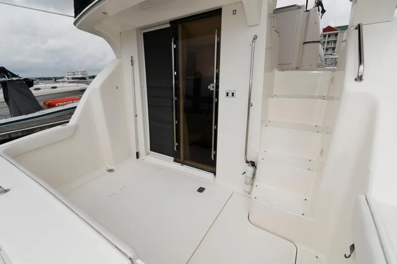 Slide: The Image of 2000 Silverton 330 Sport Bridge yacht, rear deck with stairs and sliding door. - 3