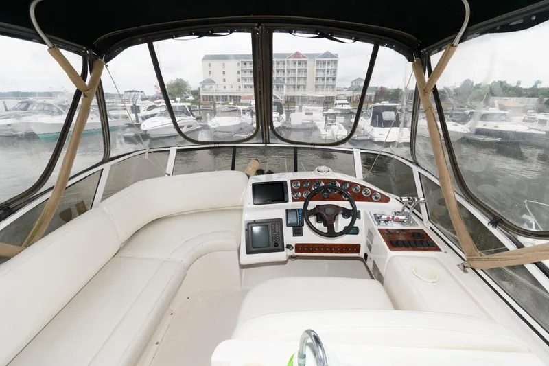 Slide: The Image of Cockpit view of a 2000 Silverton 330 Sport Bridge yacht docked at a marina. - 4