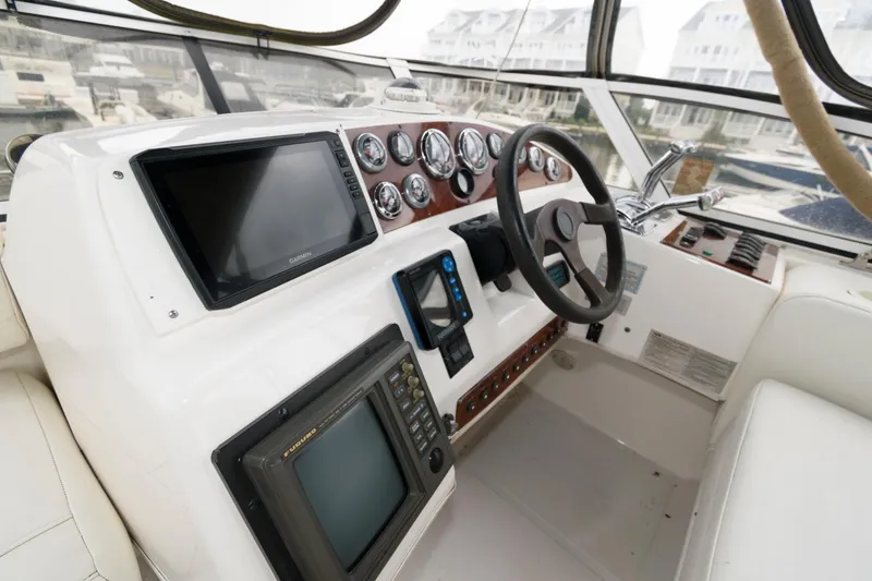 Slide: The Image of Helm of 2000 Silverton 330 Sport Bridge with navigation instruments and steering wheel. - 6