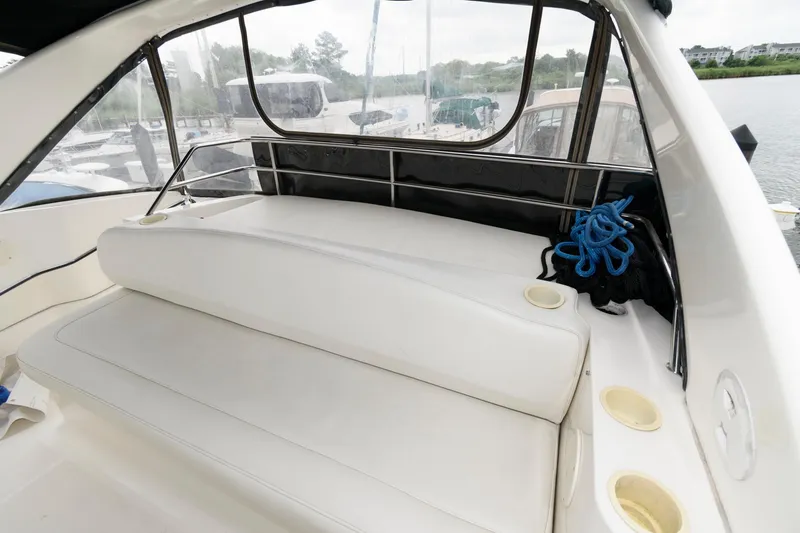 Slide: The Image of 2000 Silverton 330 Sport Bridge boat interior with white seating and cup holders. - 8