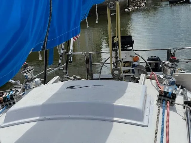 Slide: The Image of 1999 Contour 34 SC sailboat deck with blue cover and winches. - 12