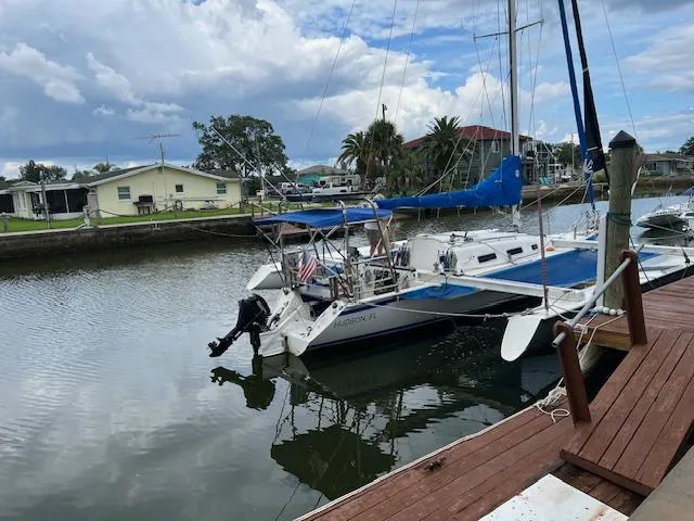 Slide: The Image of 1999 Contour 34 SC sailboat docked in a calm marina. - 2
